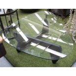 LOW TABLE, the shaped glass top on folding black base, 94cm D x 129cm W.