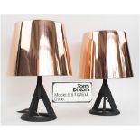 BASE TABLE LAMPS, a pair, by Tom Dixon, cast iron base with polished copper shades, 39cm H.