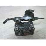SCULPTURE OF A PRANCING HORSE, contemporary style on a marble base, 44cm L x 37cm H.