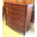 BOWFRONT CHEST, Regency mahogany with two short and four long drawers between turned columns,