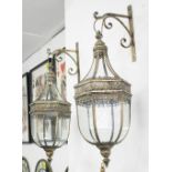 HANGING WALL LANTERNS, a pair, in glass with a brass effect filigree frame with brackets, 70cm H.