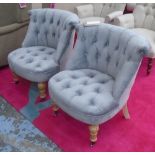 BEDROOM CHAIRS, a pair, in grey buttoned fabric on turned castor supports, 57cm W.