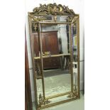 WALL MIRROR, gilt framed with rectangular and bevelled marginal plates surmounted by foliate crest,