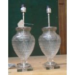 TABLE LAMPS, a pair, in glass with chromed metal mounts, 57cm H.