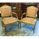 FAUTEUILS, a pair, French Louis XV design giltwood each with silk upholstery.