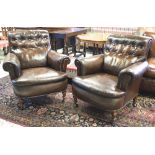 CLUB ARMCHAIRS, a pair, late 19th century beechwood in brown leather on turned legs and castors,