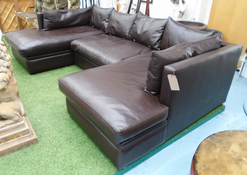 CORNER SOFA, three sections in tanned leather chaise to both sides, 298cm x 164cm.