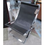 EASY CHAIR, in black leather on chromed metal 'x' framed support.