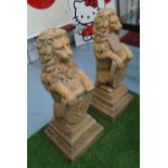 GARDEN STATUES, a pair, of lions with shields in reconstituted stone, 91cm H.