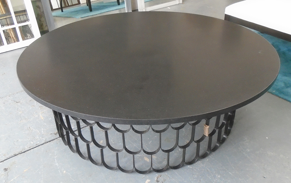 LOW TABLE, of substantial proprotions, the circular black top on a hooped metal base,