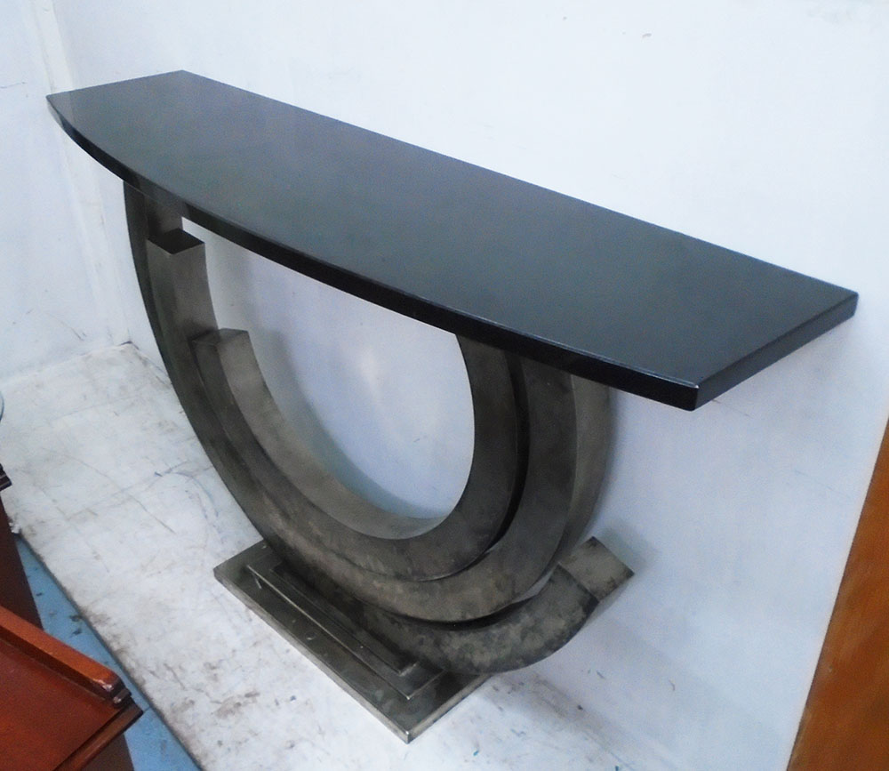 CONSOLE TABLE, the black granite top on a curved metal base, 150cm W x 41cm D x 95cm H.