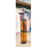 TABLE LAMP, in the form of an amber glass cylinder, 83cm H.