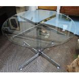 DINING TABLE, with circular bevelled glass top on chromed metal supports by Merrow Associates,