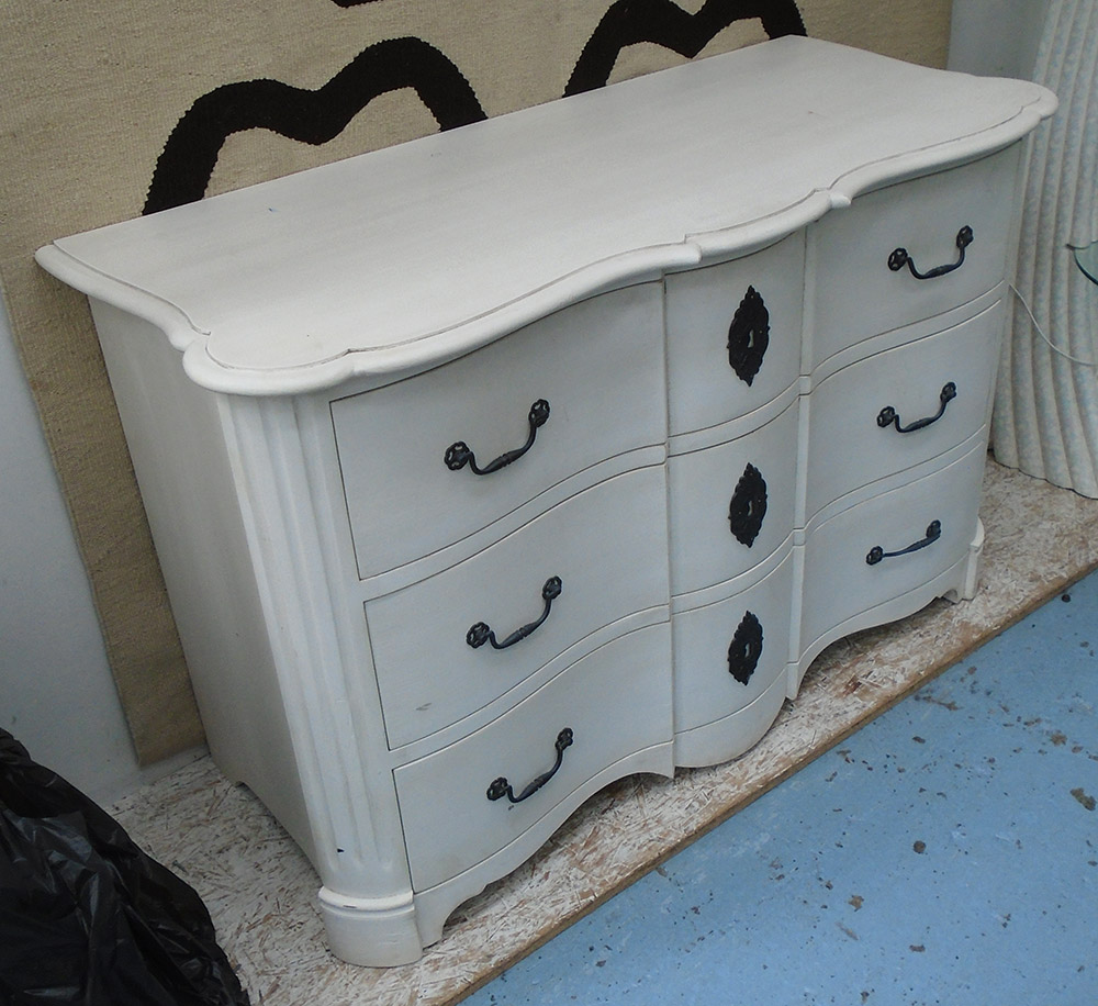 COMMODE CHEST, white, of shaped form with three drawers, 57cm D x 86cm H x 128cm W.