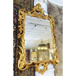 WALL MIRROR, George III style giltwood with shaped rectangular plate in a foliate scrolling frame,