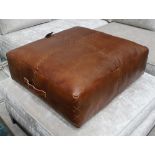 FOOTSTOOL, in tanned stitched leather with carrying handle, 70cm x 70cm x 28cm H.