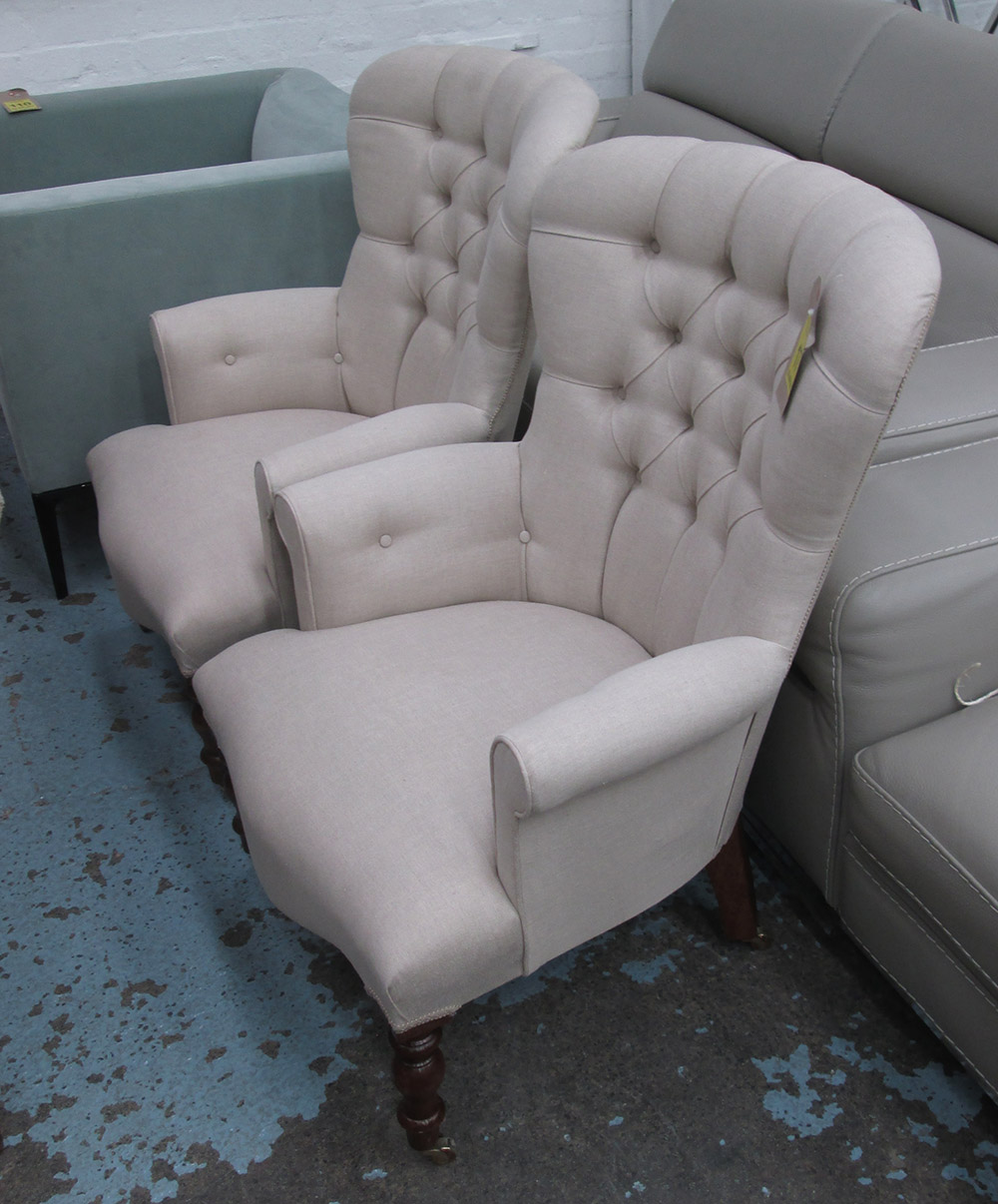 ARMCHAIRS, a pair, button back in neutral fabric on turned castor supports, 68cm W.