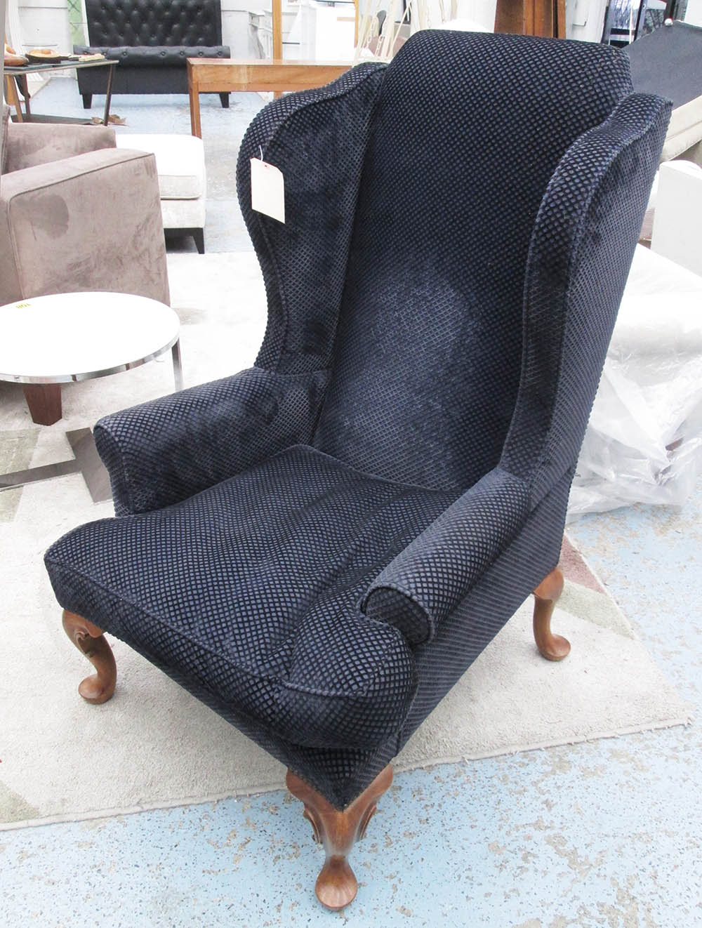 WINGBACK ARMCHAIR, in raised blue square fabric on cabriole supports, 80cm W.