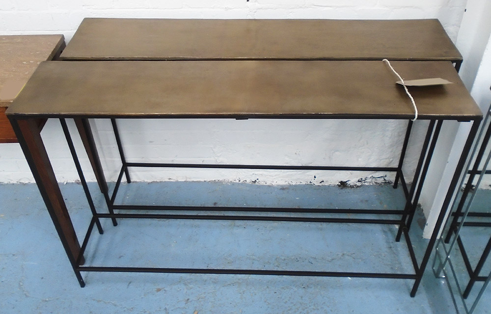 CONSOLE TABLES, a pair, in bronzed finish on square iron supports, 119cm x 25cm x 80cm H.