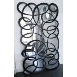 HARRISON & GIL WALL MIRROR, ebonised of large proportions with an abstract scroll design,