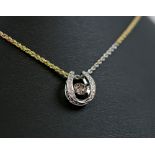 HORSESHOE PENDANT, with oscillating central 'champagne' diamond (1ct) on tri gold chain.