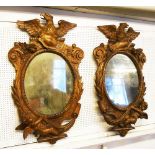 WALL MIRRORS, a pair, mid 19th century Italian walnut each with oval plate,