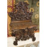 HALL BENCH, 19th century Italian walnut with lion, cherub, trophy, and grotesque mask carving,