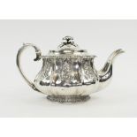 SILVER TEAPOT, George IV of lobed and footed form, embossed flowering foliate designs, London 1825,