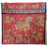 CHINESE TEXTILE, 19th century with red silk ground and worked chasing dragons in golden threads,