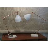 DESK LAMPS, a pair, adjustable copper coloured with white shades on a white platform base.