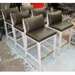 BAR STOOLS, a set of six, in green leather on stretchered legs with brass footrest.