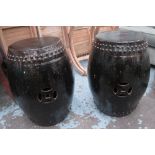 BARREL SEATS, a pair, black glazed, each approx. 60cm H x 50cm W.