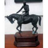 FIGURINE, horse and jockey, cast on a wooden base, 49cm W x 60cm H x 28cm D.