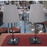 SILVERED COLUMN LAMPS, a pair, with leather bases, each 62cm H.