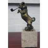 FIGURINE, gilt metal dog smoking a pipe on a travertine base, 33cm H.