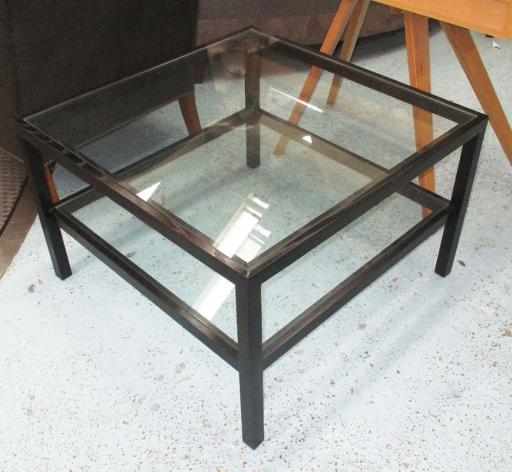 LOW TABLE, with glass top and undershelf on an ebonised frame on square supports,