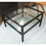 LOW TABLE, with glass top and undershelf on an ebonised frame on square supports,