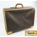 LOUIS VUITTON SUITCASE, monogram design, combination lock , 66cm W x 18cm D x 52cm H.