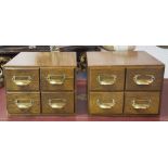 FILING CHESTS, a pair, mid 20th century oak, each with four drawers, 25cm H x 34cm W x 42cm D.