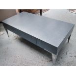 LOW TABLE, in blue leather with drawer below on chromed metal supports, 120cm x 60cm x 40cm H.
