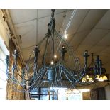 CHANDELIER, sixteen branch, green metal of large proportions, 135cm W x 114cm H.