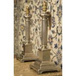 LAMPS, a pair, Classical style silvered metal each with reeded column and stepped plinth, 45cm H.