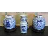 VASES, a pair, Chinese Kanxi style blue and white ceramic with covers on ebonised stands,