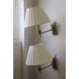 BESSELINK AND JONES WALL LIGHTS, a pair, brass with cream pleated shades, 28cm H.