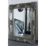 WALL MIRROR, rectangular in a silvered finish with flowerhead, leaf,
