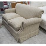 BEAUMONT & FLETCHER TWO SEATER SOFA, in neutral flecked fabric on sqaure castor supports.