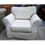 ARMCHAIR, of traditional design with a loose cream cover, 110cm W x 88cm H.