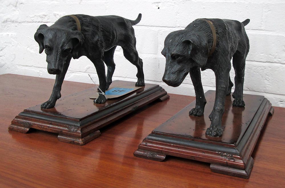 DOG FIGURINES, a pair, cast metal on wooden bases, each 37cm L x 23cm H.