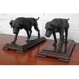 DOG FIGURINES, a pair, cast metal on wooden bases, each 37cm L x 23cm H.