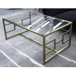 LOW TABLE, with a rectangular glass top on a gilt metal base with a geometric design,